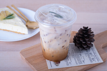 ice Latte coffee in glass with milk in the glass and coffee beans on wooden cut board on wooden...