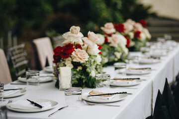 tableware Glasses, flower fork, knife served for dinner in restaurant with cozy interior
