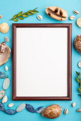 Composition with wooden frame, seashells, green boxwood. mockup on blue pastel background. top view, copy space.