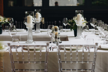 tableware Glasses, flower fork, knife served for dinner in restaurant with cozy interior