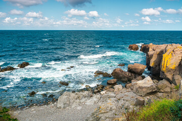 seascape of sozopol, bulgaria. wonderful scenery with cliffs in evening light. sunny weather with clouds above horizon. popular travel destination in summer