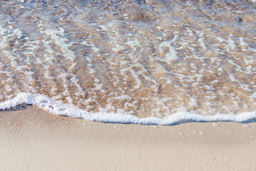 Soft wave of the sea on the sandy beach.Soft focus,blurred image.