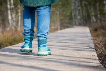 Close up woman walk in to the wild. Travel adventure and freedom concept.Woman walking outdoors, shoes closeup