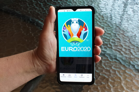 Kyiv, Ukraine - June 21, 2021: Official logo UEFA EURO 2020 on mobile screen of phone in hand