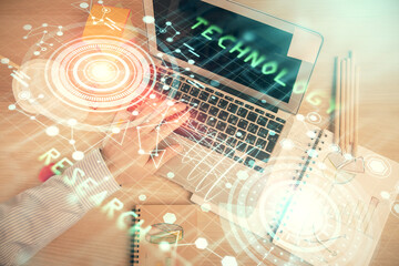 Multi exposure of man's hands typing over computer keyboard and data theme hologram drawing. Top view. Technology concept.