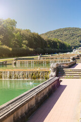Fototapeta premium Royal Palace in Caserta, Italy - April 10, 2017: Baroque style cascade fountain along the stairs in the garden of the Royal Palace