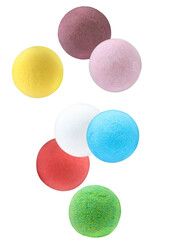 Many different aromatic bath bombs falling on white background