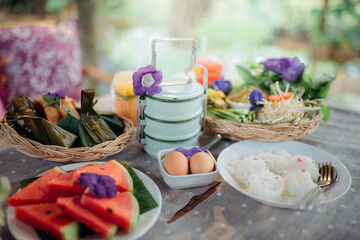 A set of traditional Thai food, dessert, drink, and fresh seasonal fruits.