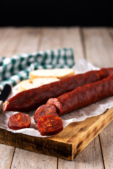 Spanish chorizo sausage on rustic wooden table