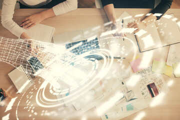 Fototapeta premium Double exposure of woman hands working on computer and data theme hologram drawing. Top View. Technology concept.