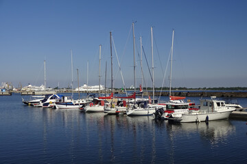 Fototapeta na wymiar Seaview in the area of Maritime museum in Seaplane Harbour (in Estonian Lennusadam). Yachts and sailing boats on the dock. A sunny summer day with a clear blue sky. Tallinn, Estonia