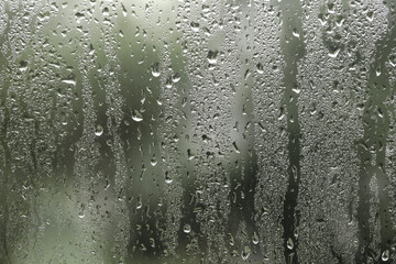 Window glass with raindrops as background, closeup