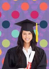 Caucasian girl wearing graduation hat and ceremony robe against colorful dots on purple background