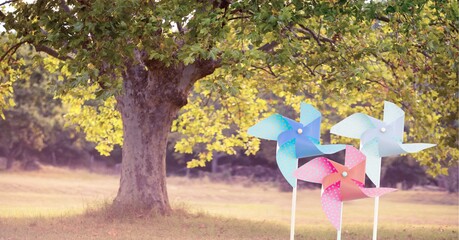 Composition of colourful windmills over trees