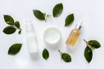 Cosmetics with natural ingredients on white table, top view