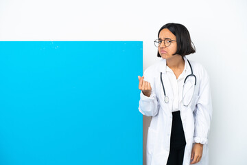 Young mixed race doctor woman with a big placard isolated on white background making Italian gesture
