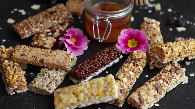 Healthy superfood composition. Various kinds granola energy protein bars with honey in jar