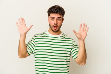 Young caucasian man isolated on white background screaming to the sky, looking up, frustrated.