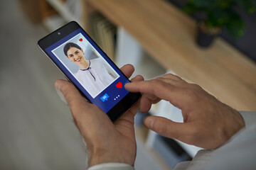 Man standing and looking through a photo of a young beautiful smiling European woman