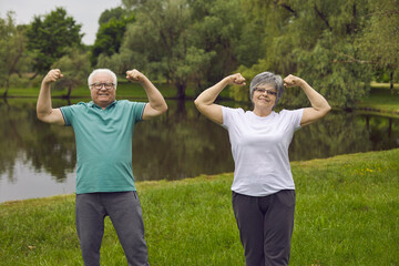 Cheerful energetic senior couple enjoy sports exercise in nature. Portrait of two happy positive...