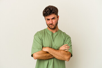 Young caucasian man isolated on white background blows cheeks, has tired expression. Facial expression concept.