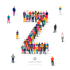 A large group of people is standing in colored clothes in the shape of the letter Z. The concept of the human alphabet.