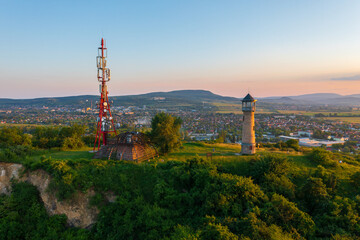 Obraz premium Beautiful aerial sunset landscape about Strazsa Hill with lookout tower which is located near Esztergom, in the Pilis Mountains. Dorog city at the background.