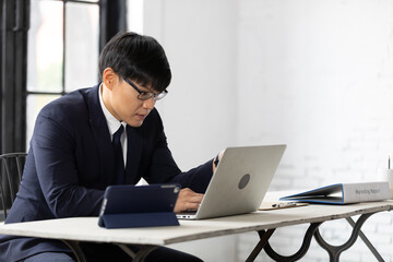Fototapeta premium young businessman working with laptop computer in office