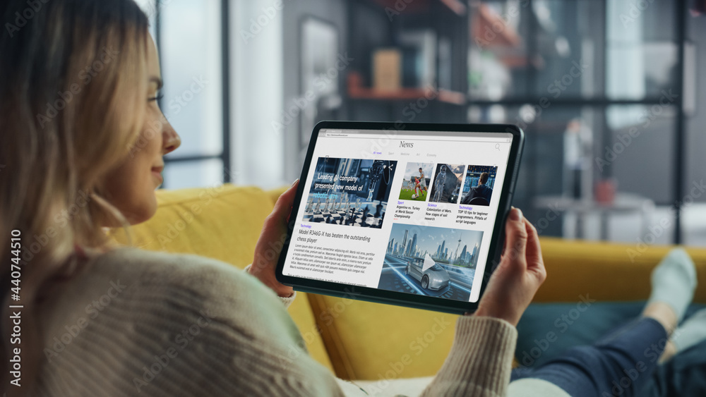 Poster beautiful authentic female using tablet computer for reading latest news and articles about technolo