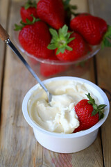 Cream cheese in a bowl and fresh strawberries. Processed Camembert cheese with strawberries.
