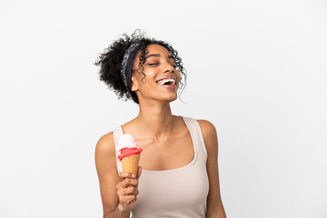 Young african american woman with a cornet ice cream isolated on white background laughing