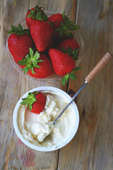 Cream cheese in a bowl and fresh strawberries. Processed Camembert cheese with strawberries.