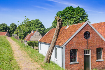 Fototapeta na wymiar Old houses at the dike in historic town Bourtange