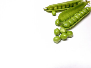 green peas in a pod in a corner on white background