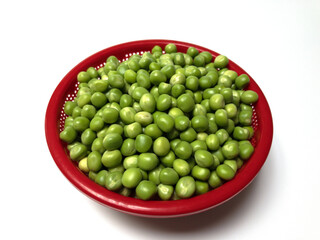 fresh green peas in a red container