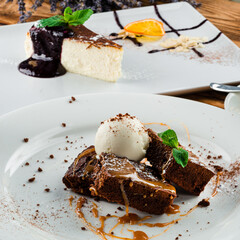 Chocolate pecan brownies with chocolate sauce, ice cream