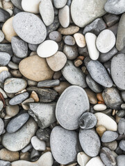Pebbles of various colors on the sea coast outdoor