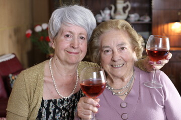 Fun senior women drinking wine 