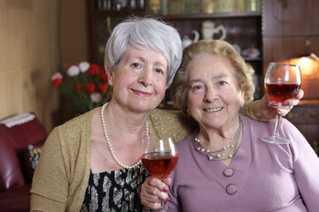 Fun senior women drinking wine