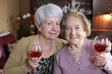 Fun senior women drinking wine 