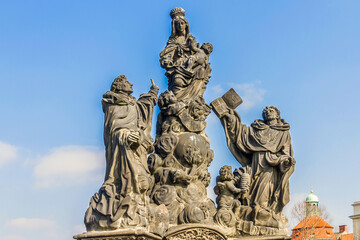 Fototapeta na wymiar Statue on Charles Bridge (Karluv most, 1357) - famous historic bridge that crosses Vltava River in Prague. Bridge decorated by 30 statues. Prague, Czech Republic.