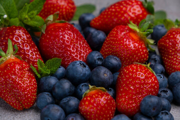 fresh strawberry and blueberry with leaves. Sweet ripe berries. Berry background. Healthy vegan food