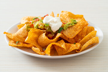 nachos tortilla chips with jalapeno, guacamole, tomatoes salsa and dip