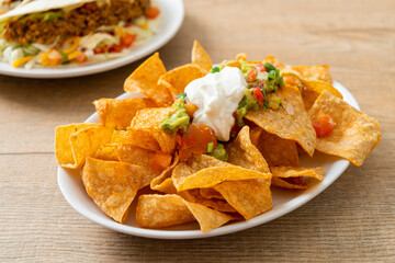 nachos tortilla chips with jalapeno, guacamole, tomatoes salsa and dip - obrazy, fototapety, plakaty