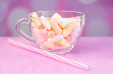 Marshmallows in a mug On a bright pink background