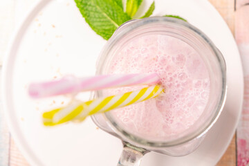 Beautiful appetizer pink raspberry berry fruit smoothie. Yogurt cocktail. Close up. Natural detox. Liquid ice cream. Glass of raspberry milkshake