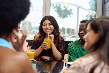 Lifestyle and friendship concepts with real people models. Multinational friends chatting in a...