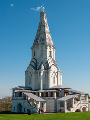 Moscow, Russia - May 1, 2021: Bright sunny spring day in Kolomenskoye park, Moscow. People with families walk near the Church of the Ascension of the Lord in a large park and enjoy the good weather.