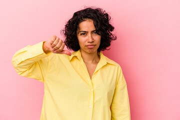 Young curly latin woman isolated on pink background showing a dislike gesture, thumbs down....