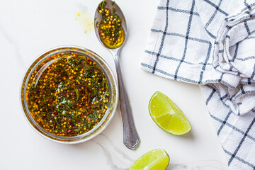 Mustard, olive oil and dill salad dressing in glass jar. Cooking healthy food concept.